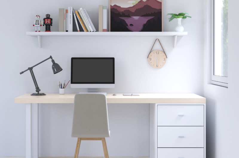 image of a desk against a wall with a shelf above it; demonstrating how to set up a home office for success