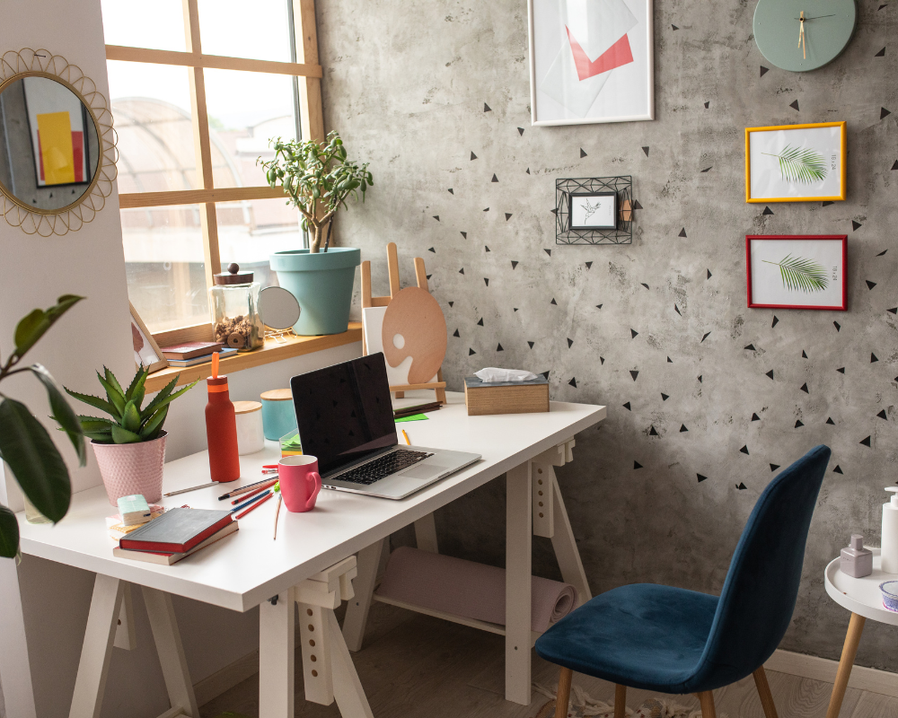 image of a desk in the corner of a room under a window; demonstrating how to set up a home office for success